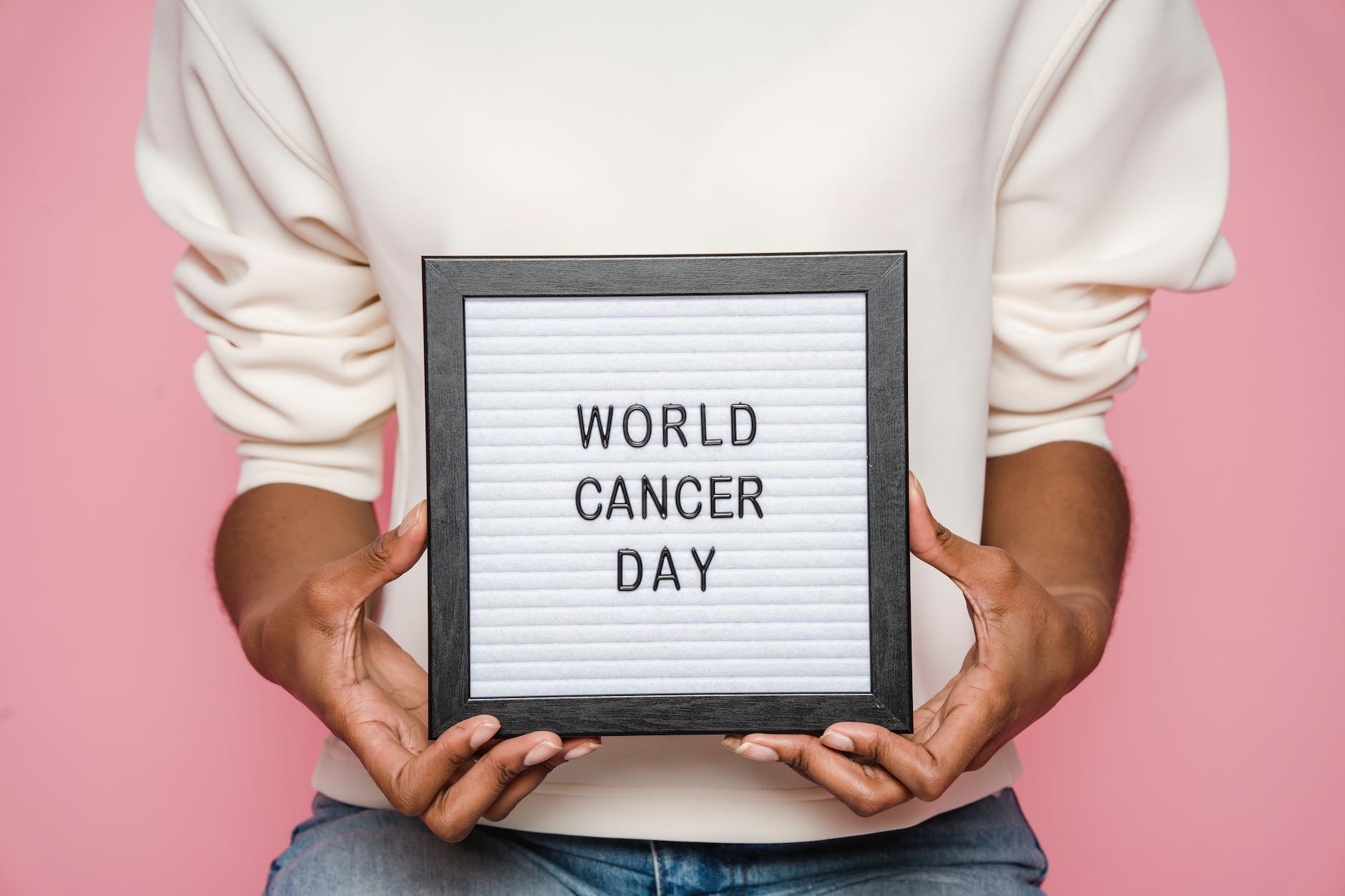 black person showing letterboard with world cancer day inscription